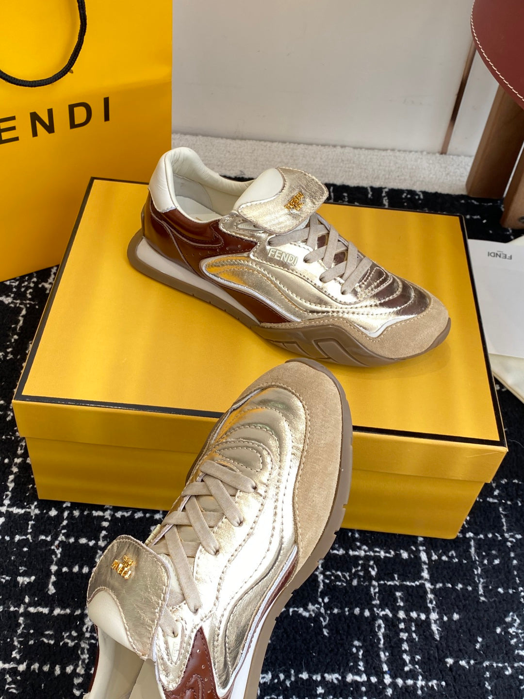 Fendi sneakers: metallic silver and tan-brown panels, white laces, chunky sole.