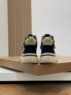 Back view of navy and cream high-top sneaker with beige heel tab