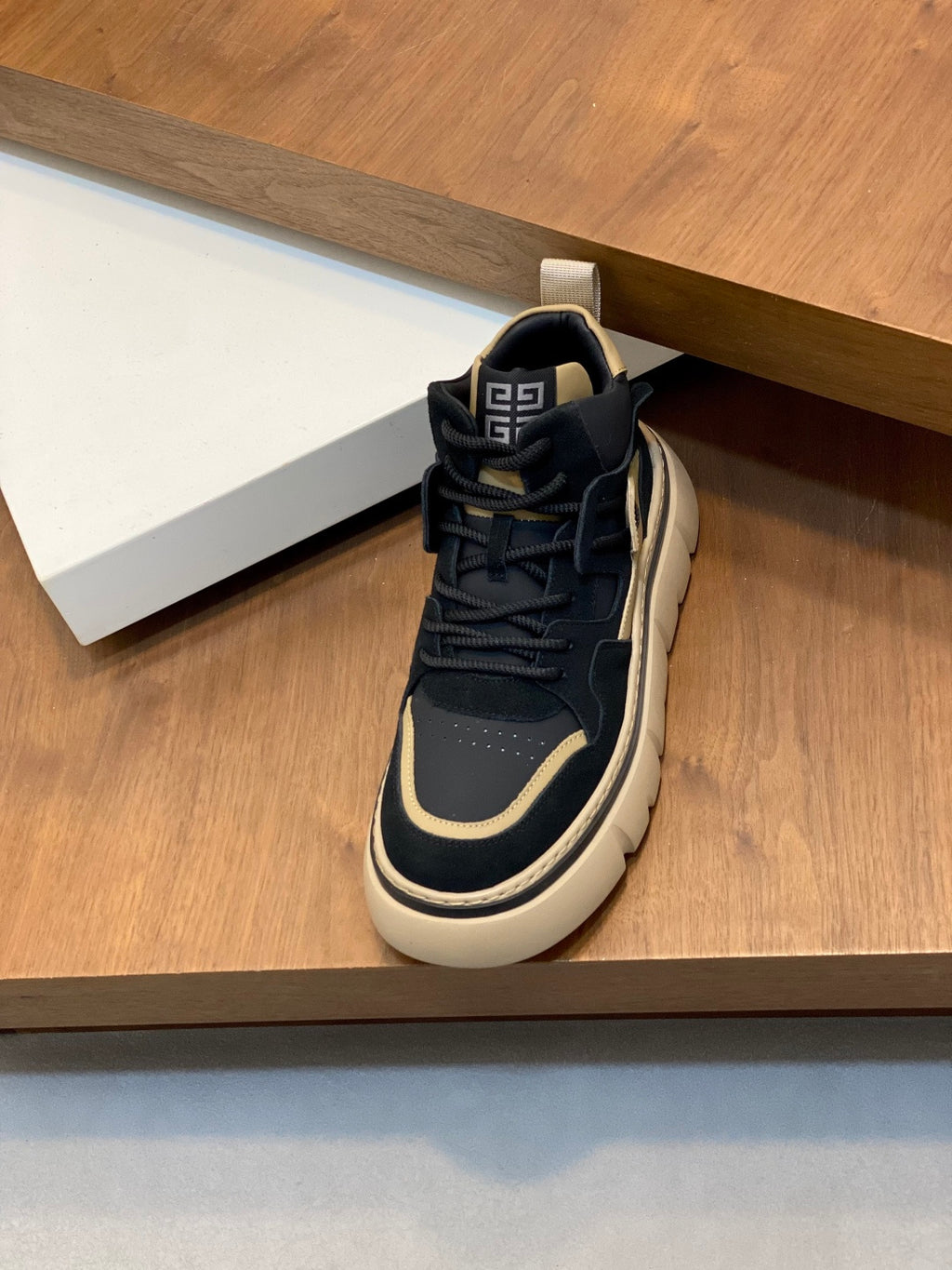 Navy and cream high-top sneakers with lace-up closure and heel tab