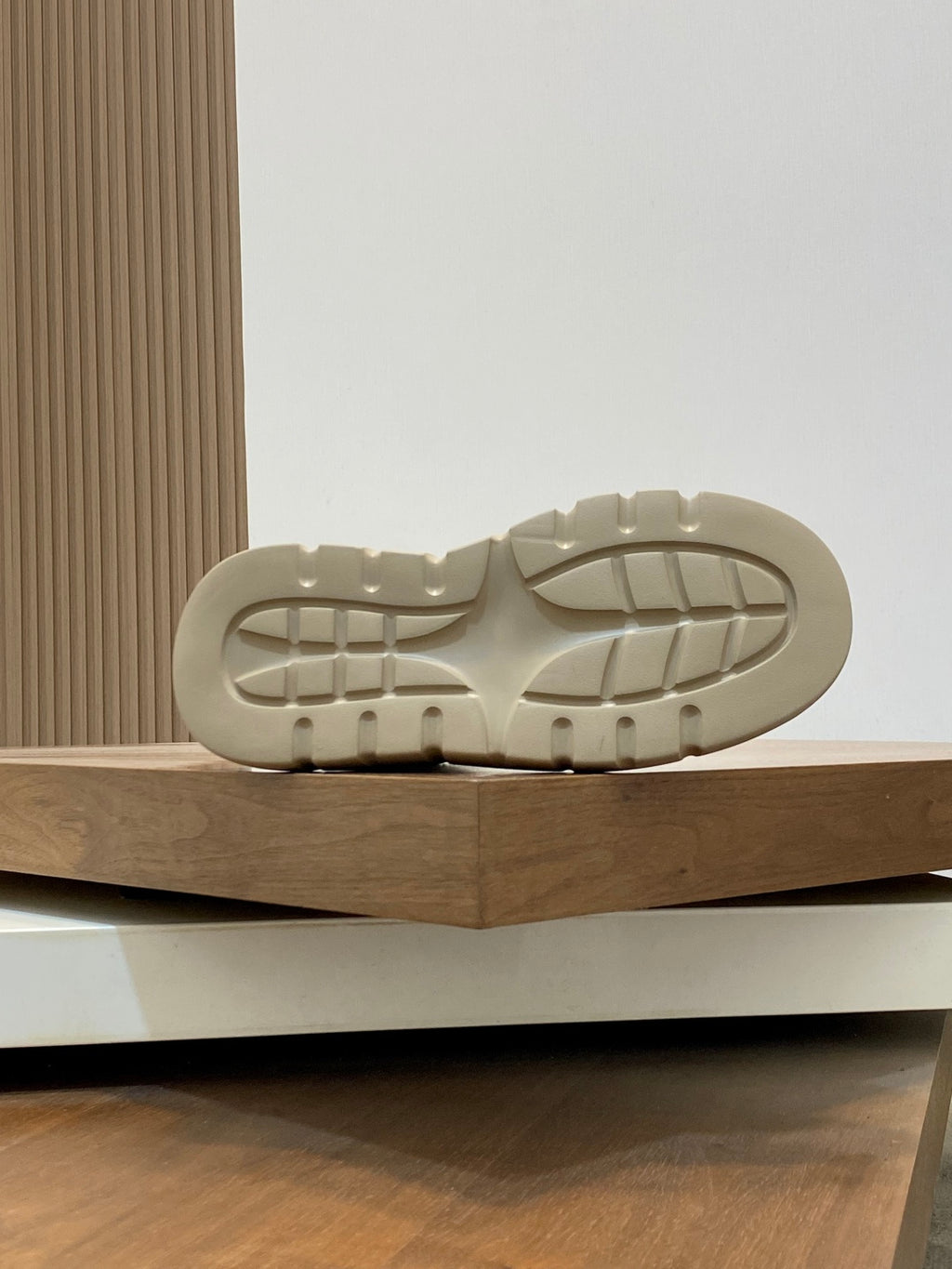 Shoe outsole view with textured tread and chunky platform shape.
