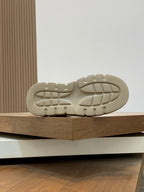 Shoe outsole view with textured tread and chunky platform shape.