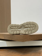 Cream rubber sneaker outsole with tread pattern and molded side edge