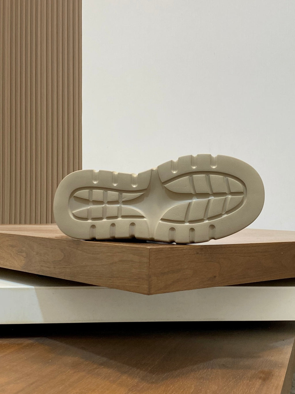 Navy and cream sneaker outsole with tread pattern