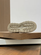 Givenchy luxury shoes, outsole view of cream sneakers with tread pattern on chunky sole