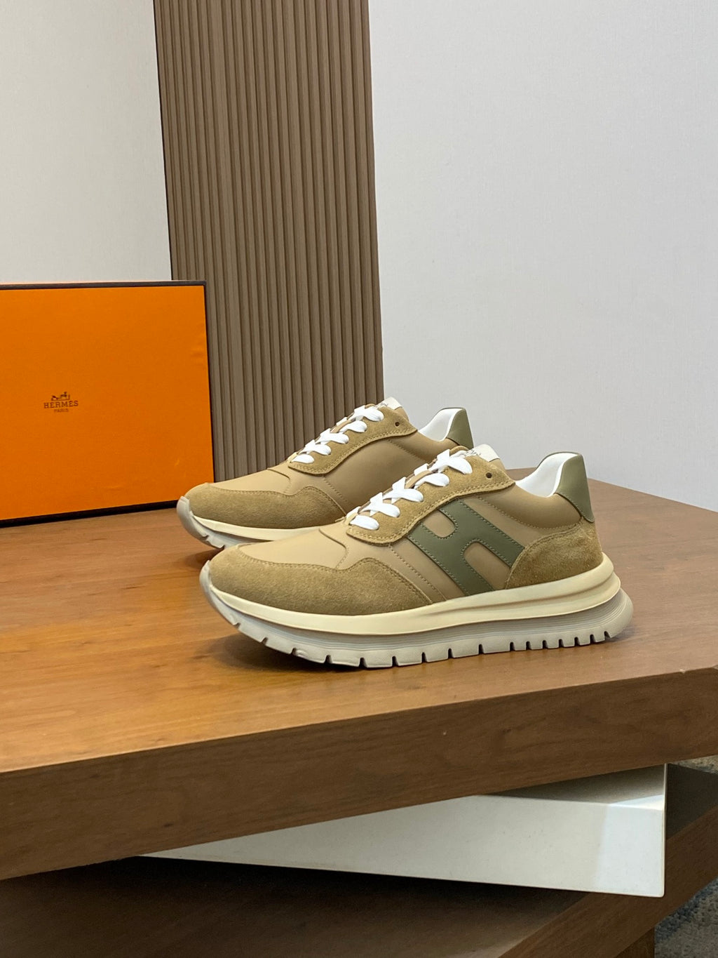 Beige suede sneakers with green side stripe and white lace-up design