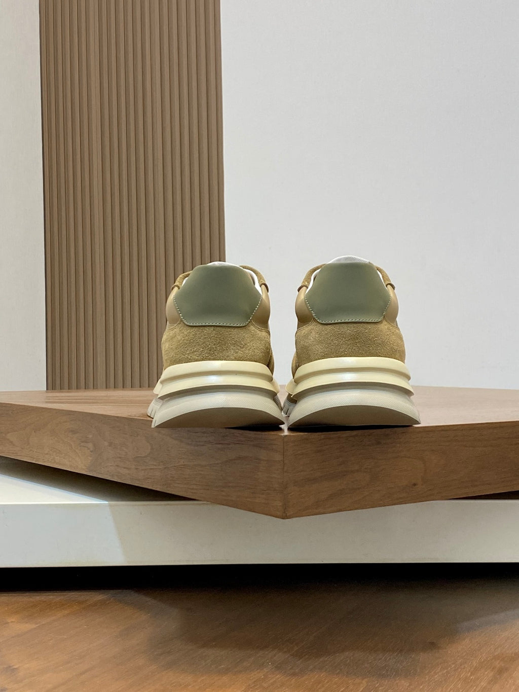 Beige sneakers with green heel tabs and white midsoles