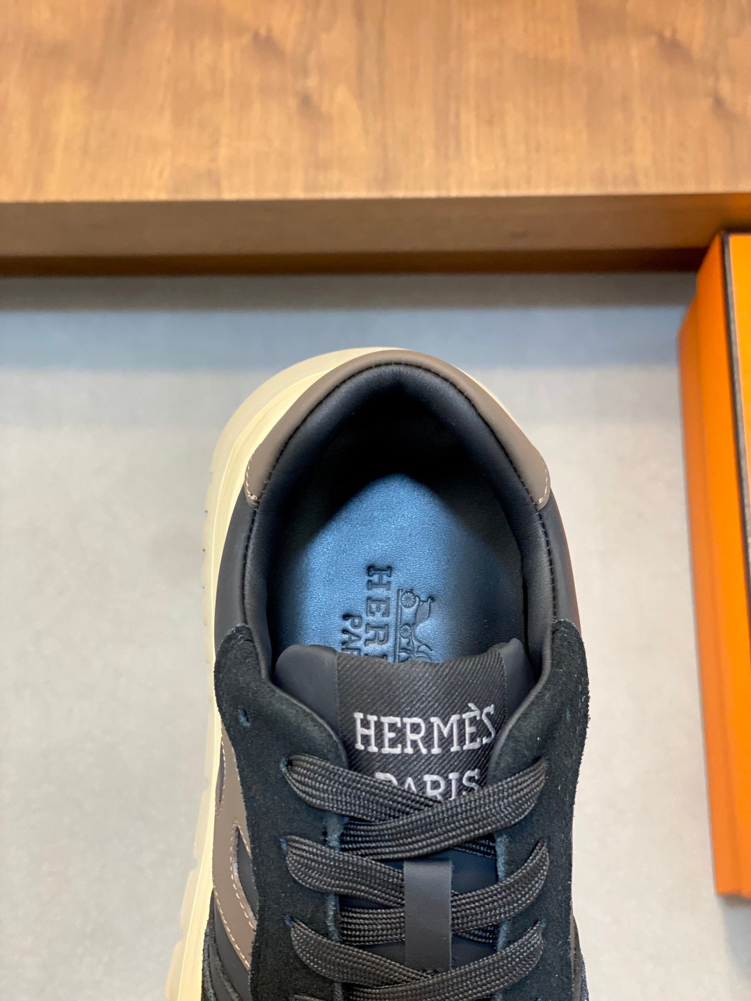 Black lace-up sneakers with HERMES logo on tongue and padded collar