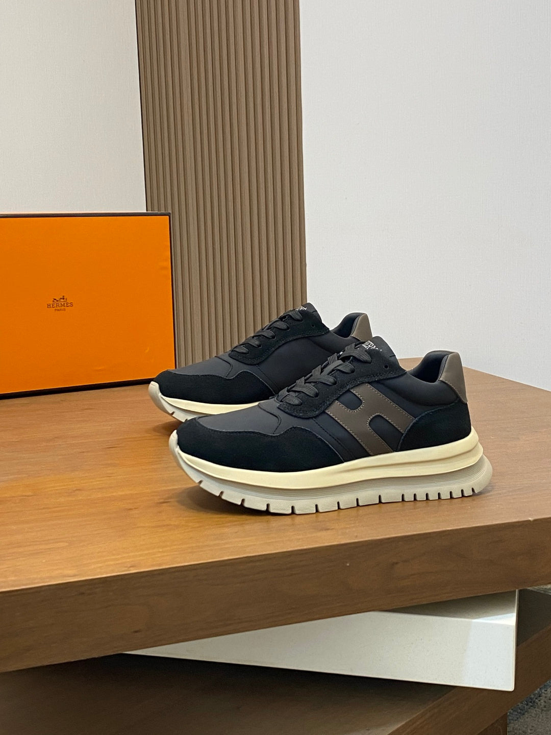 Navy lace-up sneakers with gray side panels and cream sole