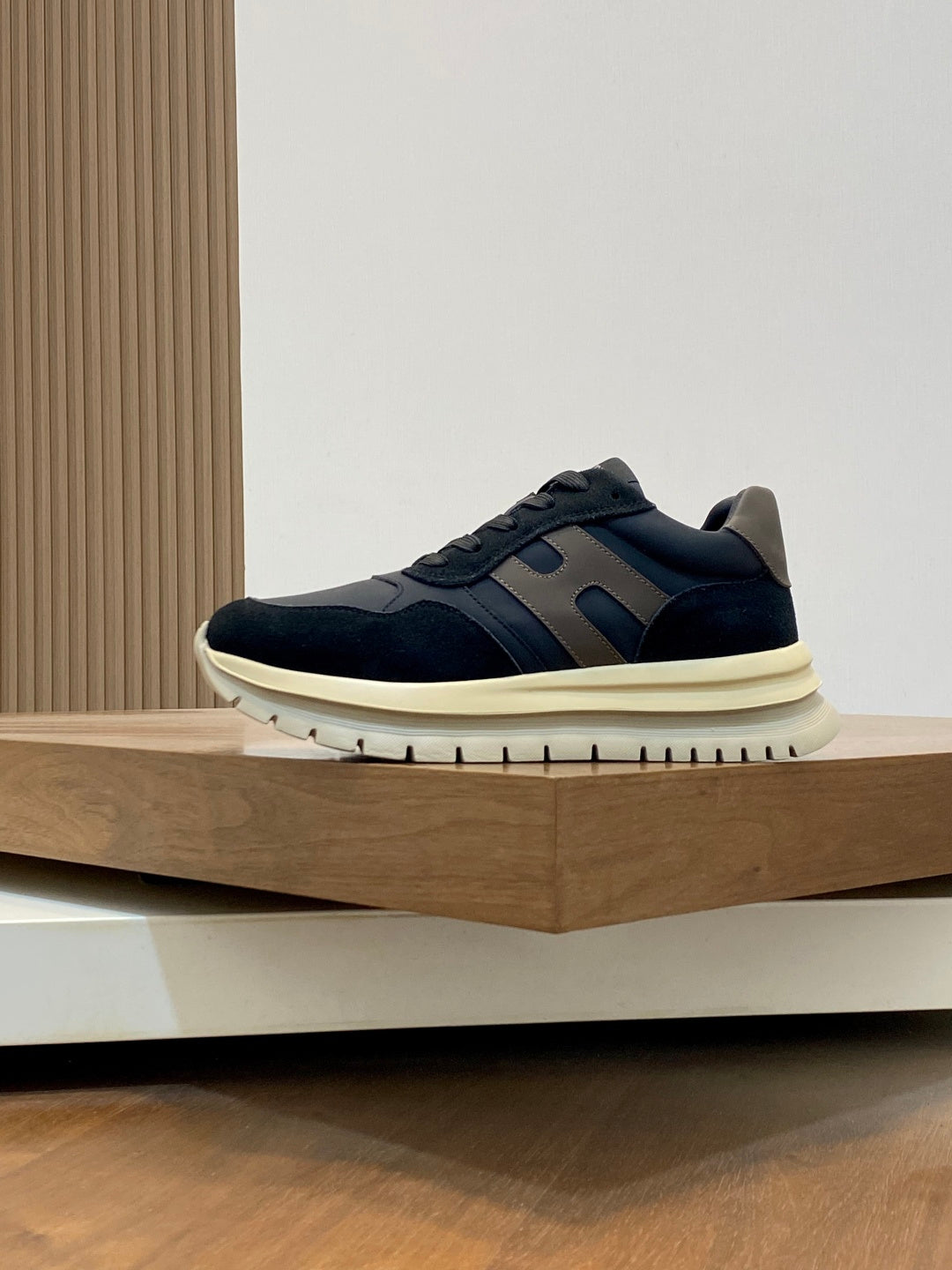 Navy lace-up sneakers with blue side stripes and cream rubber sole