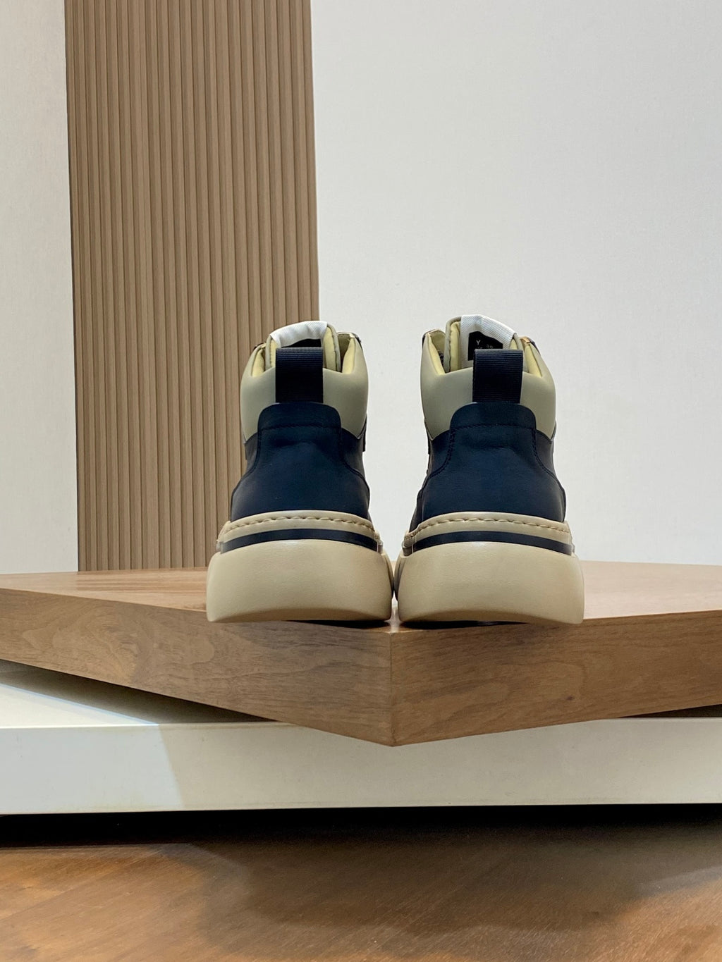 Navy sneakers with cream soles and heel tabs, contrast piping, and lace-up closure