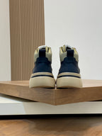 Navy sneakers with cream soles and heel tabs, contrast piping, and lace-up closure