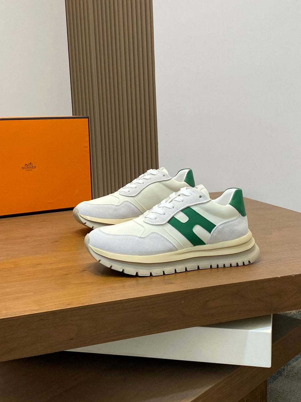 White sneakers with green side stripes and black tread sole, side view pair