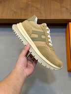 Beige suede sneakers with green inserts and white rubber sole