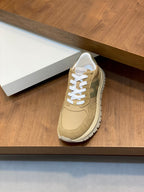 Beige suede Moncler sneakers with white laces and cushioned tongue