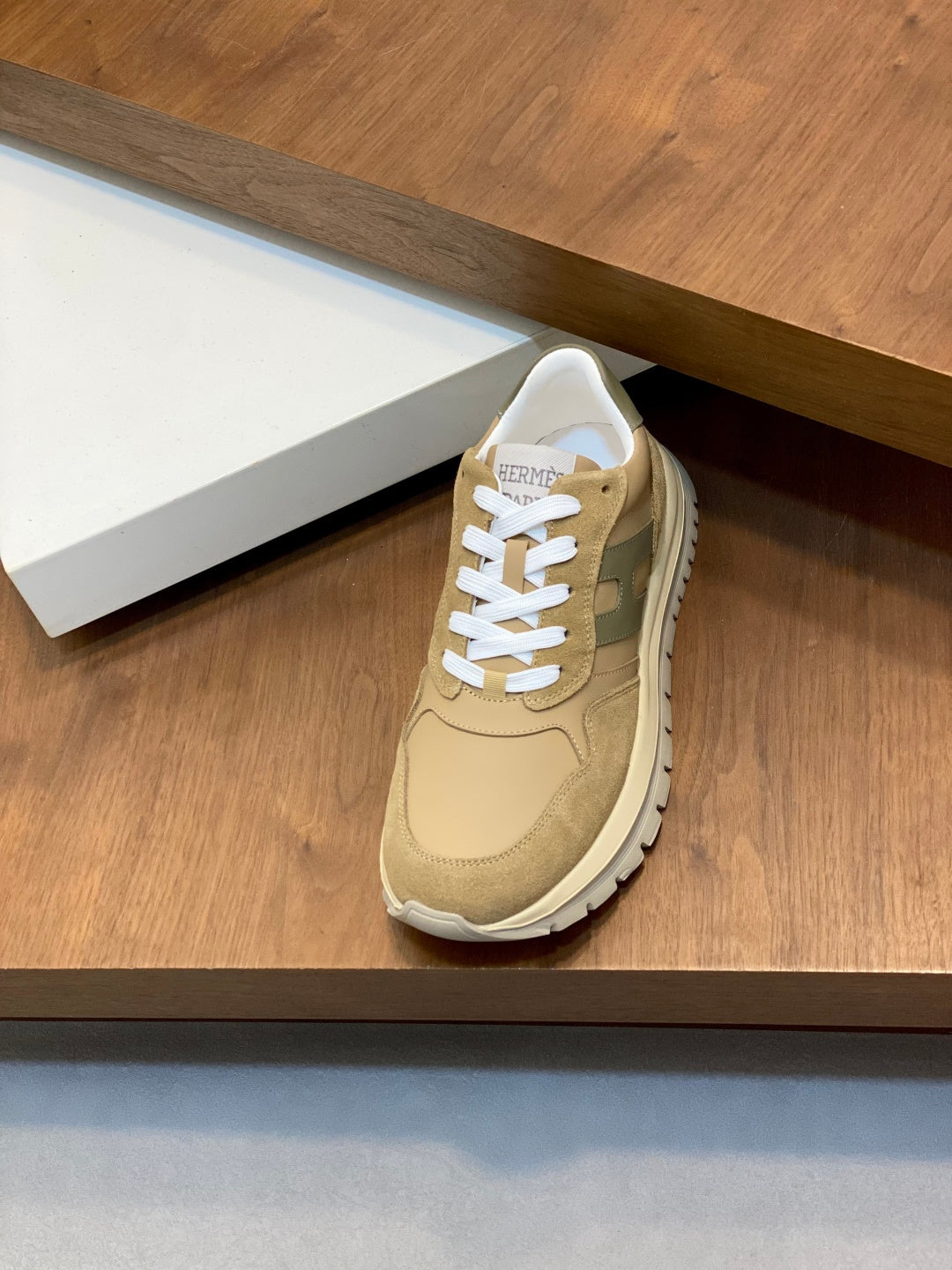 Beige suede Moncler sneakers with white laces and cushioned tongue