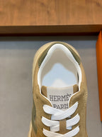 Shoe tongue detail with "HERMES PARIS" text and white lace
