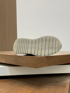 Cream rubber sneaker outsole with ridged tread