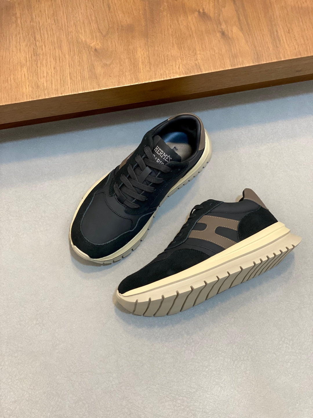Navy lace-up sneakers with gray side accents and cream rubber sole
