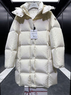 Light cream long puffer coat with hood, diamond quilting, front button placket, cuffs.