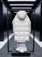 Back of long quilted puffer coat with hood, light cream, diamond stitching.