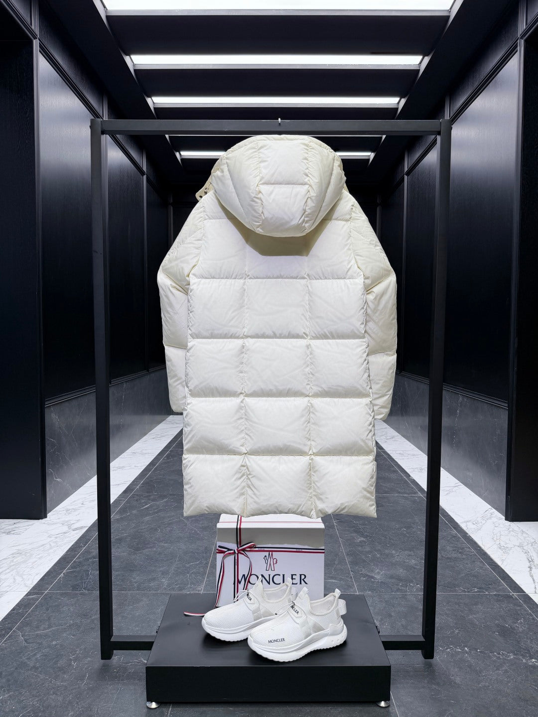 Back of long quilted puffer coat with hood, light cream, diamond stitching.