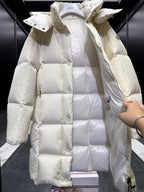 Light cream long puffer coat with hood, diamond quilting, raised collar and cuff tabs.