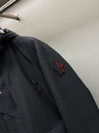 Moncler black long parka sleeve with embroidered logo patch and zip pocket