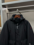 Moncler black long hooded parka with central placket and chest logo print