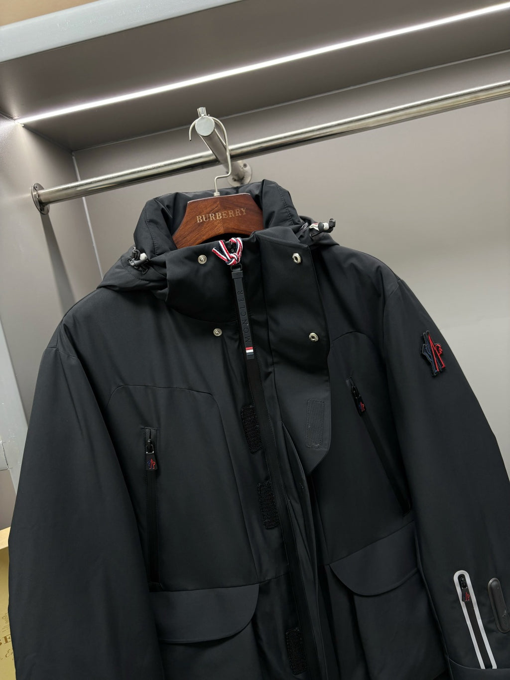 Moncler black long hooded parka with drawstring hood, button front, logo patch
