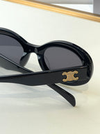 Black sunglasses side view with gold logo on the temple and dark lenses