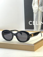 Black round sunglasses with dark lenses and gold side logo detail
