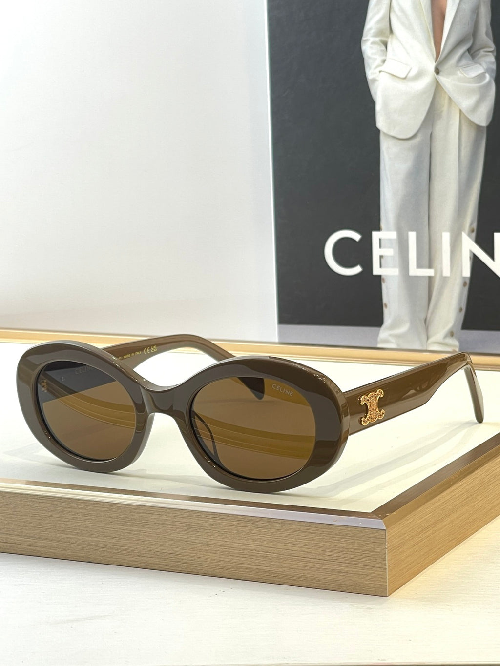 Tortoiseshell round sunglasses with brown-tinted lenses and gold temple logo