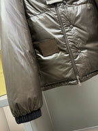 Olive puffer jacket sleeve detail with snap placket and elastic cuff