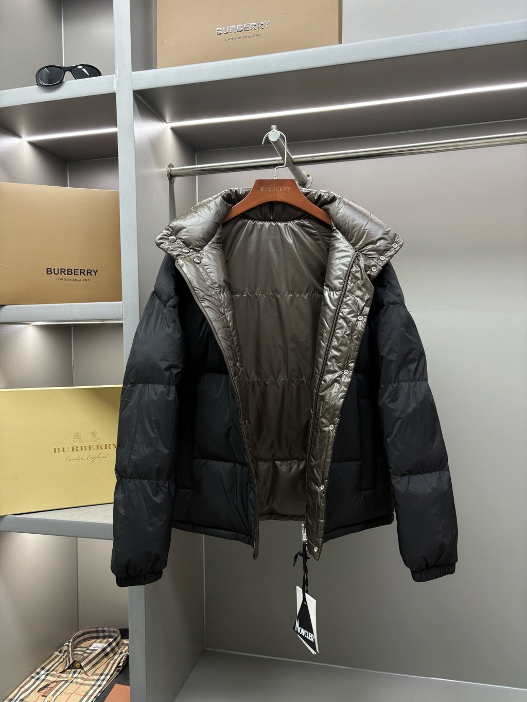 Olive puffer jacket with stand collar and full-zip, hood opening visible