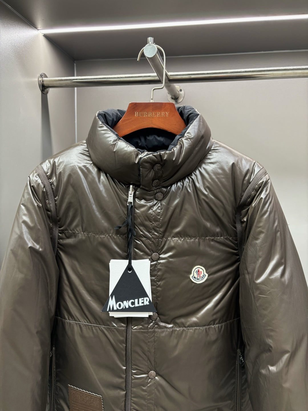 Olive puffer jacket with stand collar, full-zip front and chest logo patch