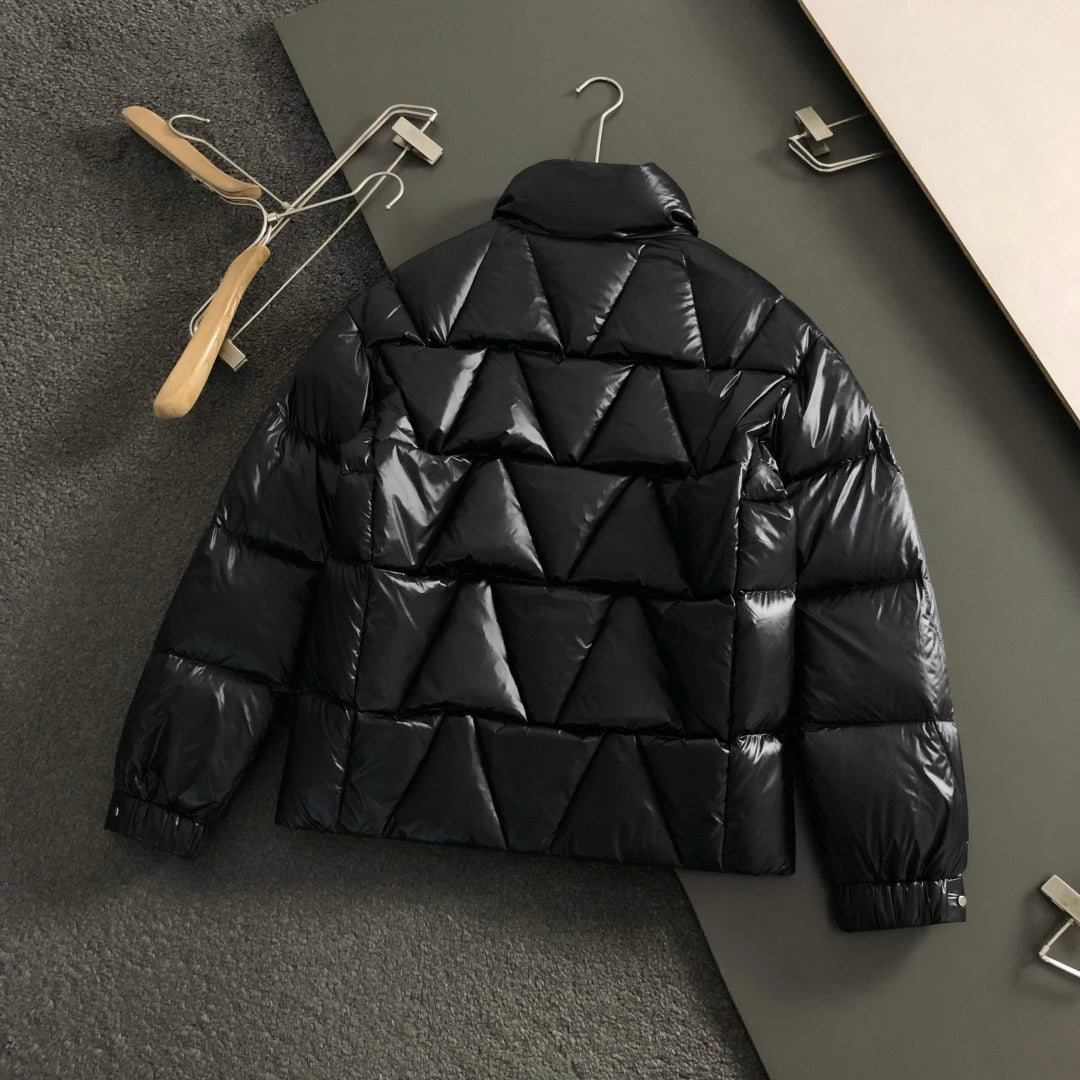 Black quilted puffer jacket back with raised shoulders and puffed panels