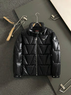 Black zip-front puffer jacket with stand collar and Prada patch logo