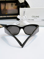 Cat-eye sunglasses with black frames and dark lenses, front view.