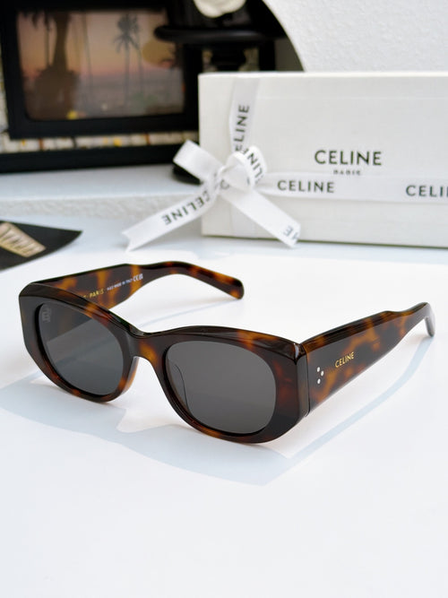 Cat-eye sunglasses with tortoise frames and dark gray lenses.