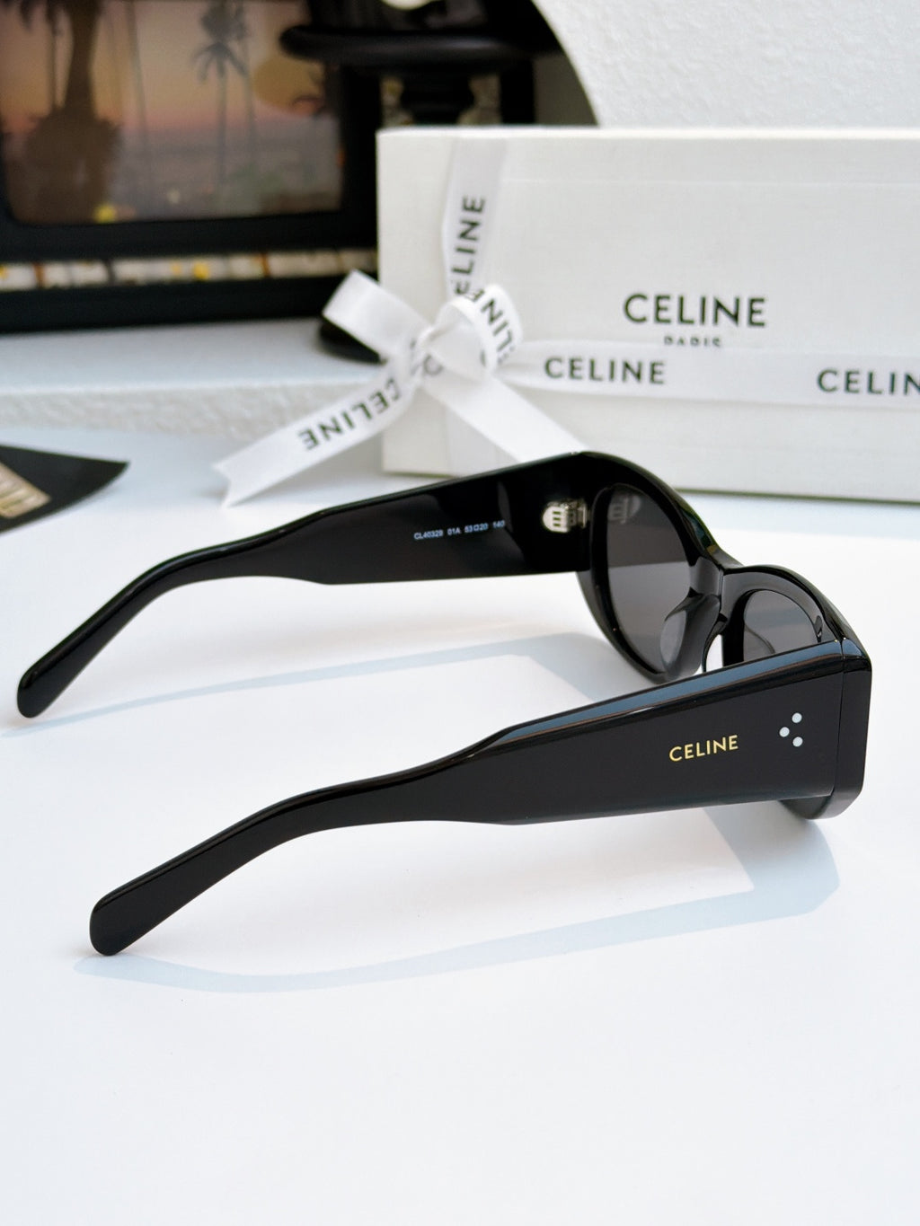 Cat-eye sunglasses with black frames and dark lenses, angled side view.