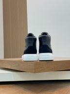 Back view of black high-top sneakers with white heel branding