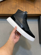 Black high-top sneaker upper with lace-up eyelets and white rubber sole