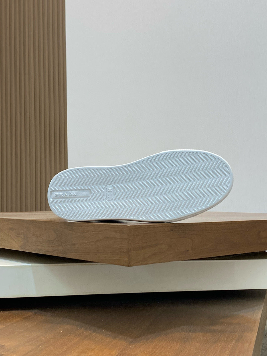 Outsole of black high-top sneakers with white zigzag tread