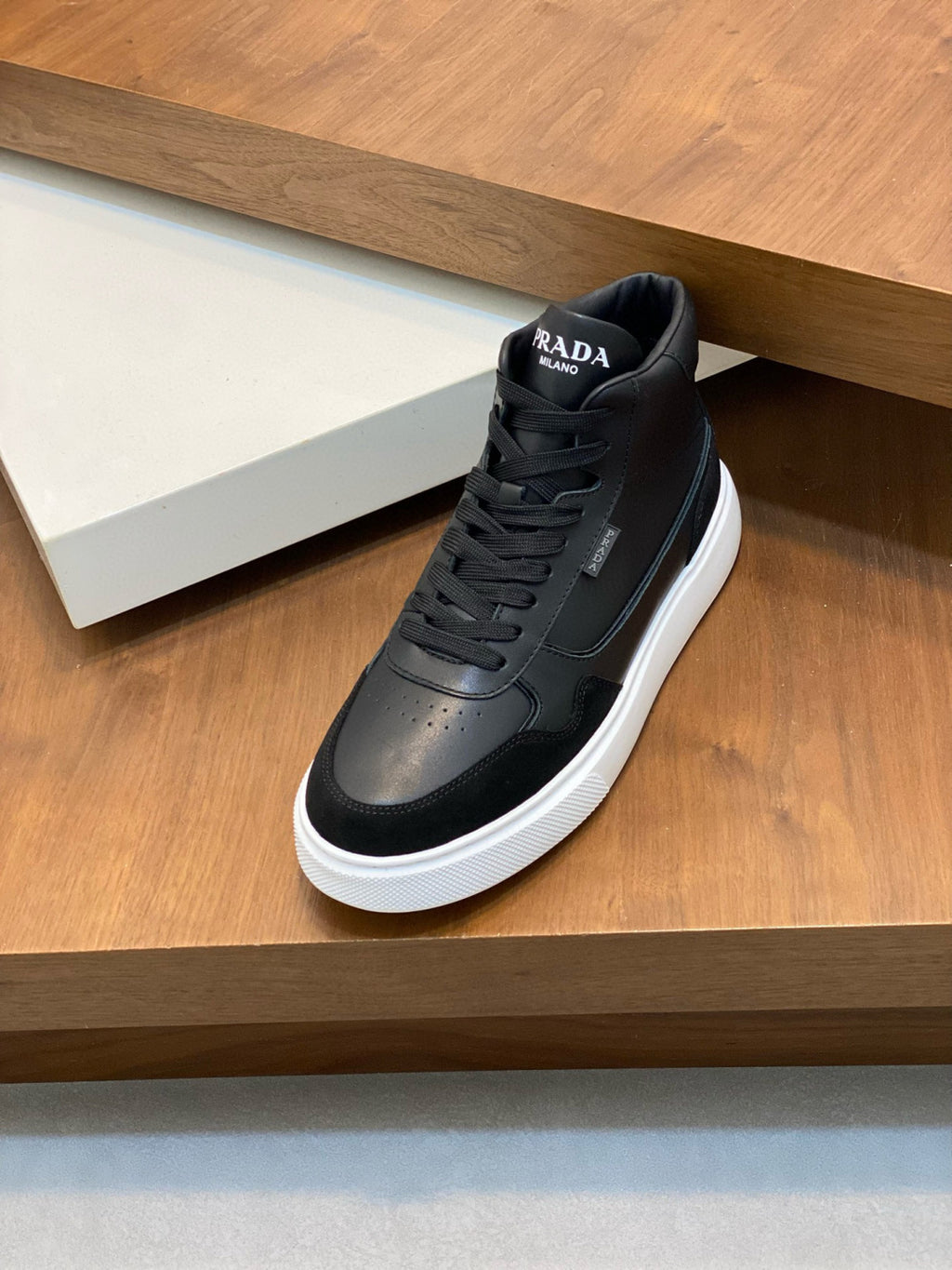 Black lace-up high-top sneaker with white rubber sole