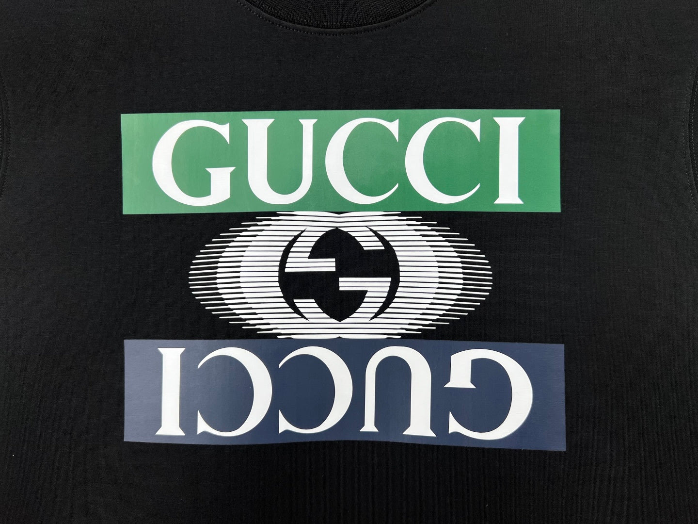 Black crewneck sweatshirt graphic: Gucci text and swirl heart logo