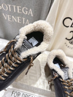 Golden Goose black sneaker close-up: gold lace hardware, fuzzy shearling collar lining