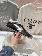 Golden Goose black sneaker with white star panel, shearling collar, gold laces, gum sole