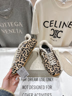 Leopard-print low-top sneakers with sherpa lining, white laces, gum outsole
