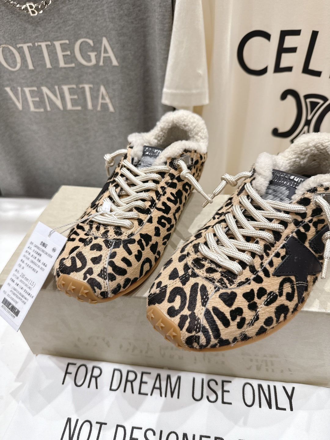 Pair of leopard-print sneakers with sherpa trim, white laces, and gum soles