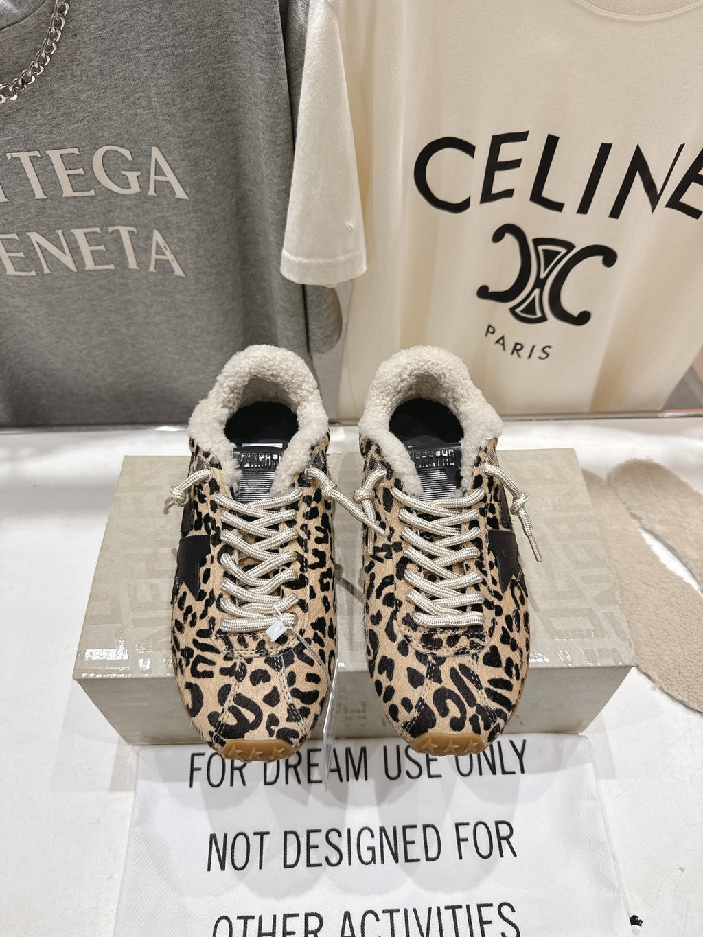 Leopard-print sneakers with sherpa trim, white laces, and textured gum soles